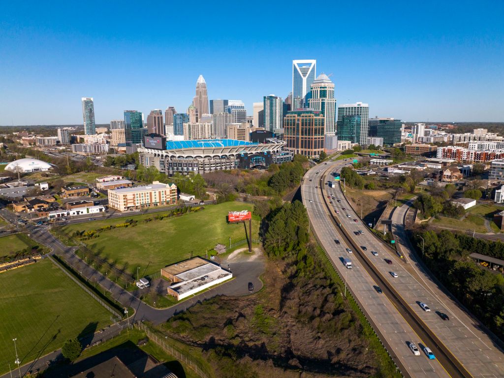 Aerial View of Charlotte, North Carolina on clear day showing highways and skyline